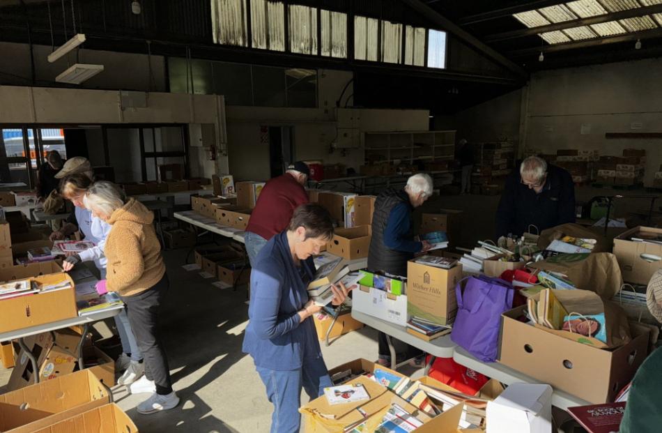 Rotary and Inner Wheel members have been busy sorting books into various categories. Photo: Supplied