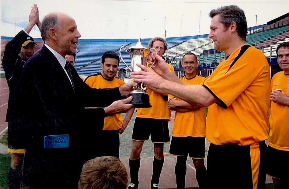 Bolam-Smith presents New Brighton Rovers captain John McManus with the Bolam Cup at QEII Stadium...