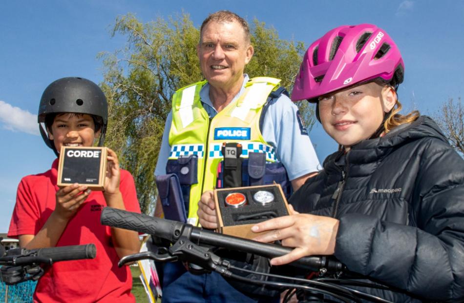 Senior Constable Jim Manning helped James Rizvi, 11, and Mikayla Vargo, 10, fit their new bike...