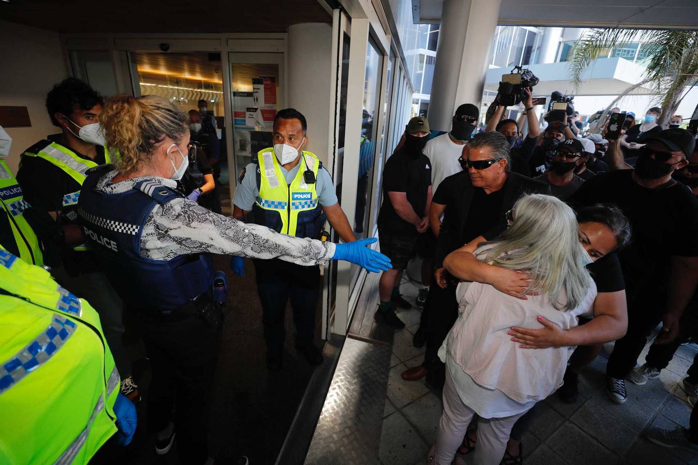 Hannah Tamaki is hugged by a supporter outside the police station today. Photo: NZ Herald 