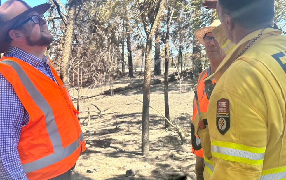 Waimakariri mayor Dan Gordon (left) looks over scorched trees where a fire has been burning in...