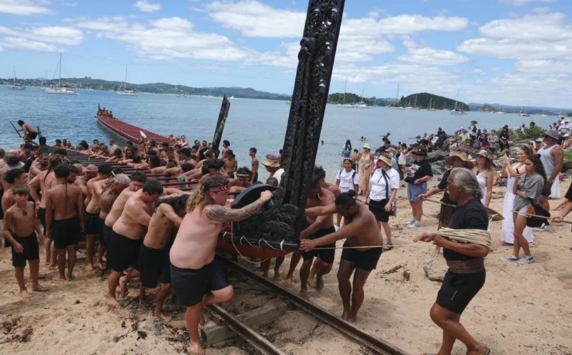 The waka Mātaatua is pulled from the water, to be returned to its whare for another year. Photo: RNZ